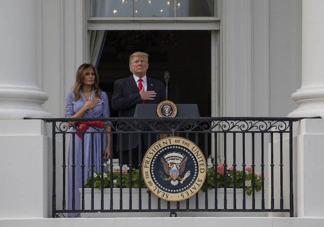 US President Donald Trump and first lady Melania Trump stand for the National Anthem during a picnic for military families on the South Lawn of the White House on July 4, 2018 in Washington, DC. (Photo by Alex Edelman/Getty Images)