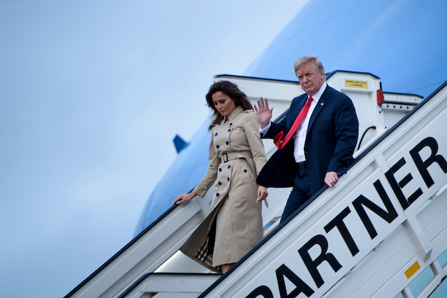 US President Donald Trump (R) and US First Lady Melania Trump disembark from Air Force One as they arrive at Melsbroek Air Base in Haachtsesteenweg on July 10, 2018. - US President Donald Trump has arrived in Brussels on the eve of a tense NATO summit where he is set to clash with allies over defence spending. Trump arrived on Air Force One at Melsbroek military airport, shortly after saying on Twitter that NATO allies should "reimburse" the United States for spending on the alliance. (Photo credit: BRENDAN SMIALOWSKI/AFP/Getty Images)