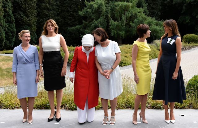 NATO Leaders spouses (L/R): Slovenian Prime Minister's wife Mojca Stropnik , Bulgarian President's wife Desislava Radeva, Turkish President's wife Emine Erdogan, NATO Secretary General's wife Ingrid Schulerud, Belgian Prime Minister's partner Amelie Derbaudrenghien and US First Lady Melania Trump pose during a visit to the The Queen Elisabeth Music Chapel in Waterloo on July 11, 2018, on the sidelines of the first day of the North Atlantic Treaty Organisation (NATO) summit in Belgium. (Photo credit: RICCARDO PAREGGIANI/AFP/Getty Images)