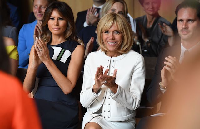 French President's wife Brigitte Macron (R) and US First Lady Melania Trump applaud a musical performance during a visit of the NATO Leaders spouses to the The Queen Elisabeth Music Chapel in Waterloo on July 11, 2018, on the sidelines of the first day of the North Atlantic Treaty Organisation (NATO) summit in Belgium. (Photo credit: RICCARDO PAREGGIANI/AFP/Getty Images)