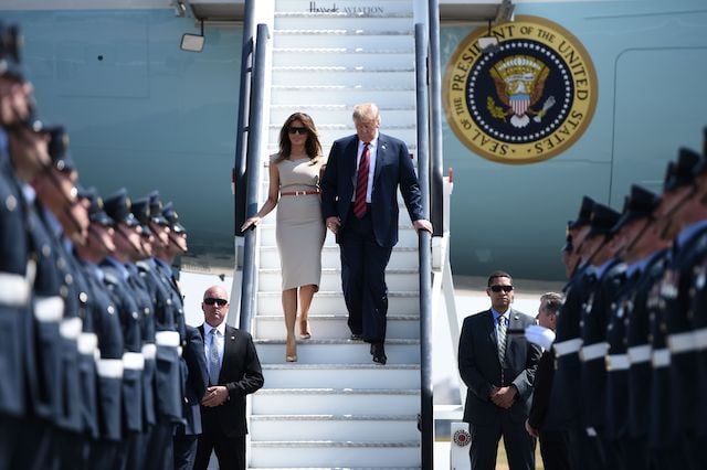 US President Donald Trump (R) and US First Lady Melania Trump (L) disembark Air Force One at Stansted Airport, north of London on July 12, 2018, as he begins his first visit to the UK as US president. - The four-day trip, which will include talks with Prime Minister Theresa May, tea with Queen Elizabeth II and a private weekend in Scotland, is set to be greeted by a leftist-organised mass protest in London on Friday.(Photo credit: BRENDAN SMIALOWSKI/AFP/Getty Images)
