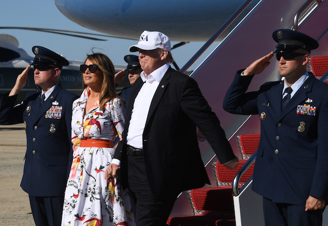 US President Donald Trump and First Lady Melania Trump step off Air Force One upon arrival at Andrews Air Force Base in Maryland following a weekend at the Trump National Golf Club in Bedminster, New jersey. (Photo credit: WATSON/AFP/Getty Images)