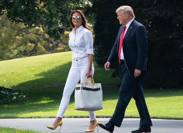 US President Donald Trump and First Lady Melania Trump walk to board Marine One at the White House in Washington, DC, on July 27, 2018 as they head to spend the weekend in New Jersey. (Photo credit: NICHOLAS KAMM/AFP/Getty Images)