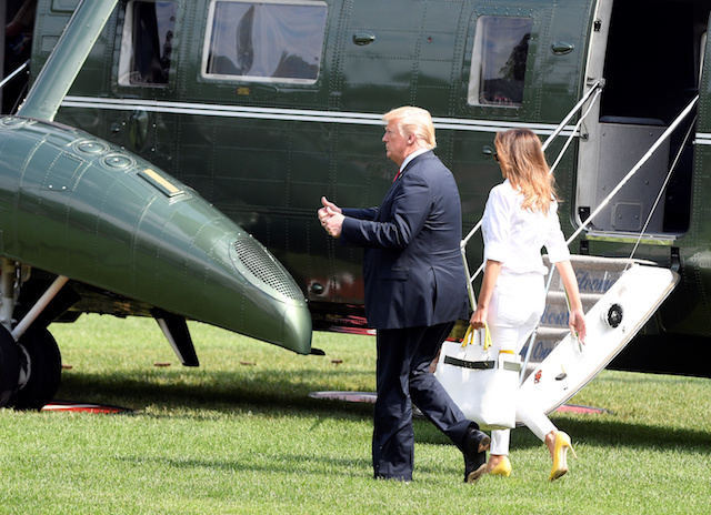 U.S. President Donald Trump and First Lady Melania Trump walk to Marine One upon departure from the White House, in Washington, U.S., July 27, 2018. REUTERS/Mary F. Calvert 
