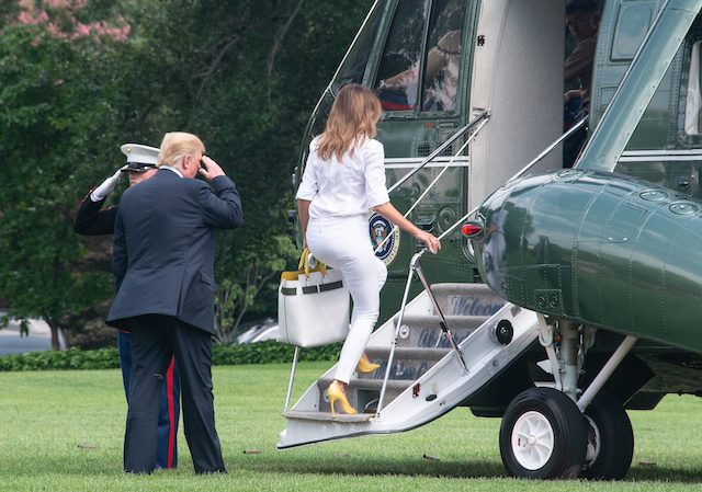 US President Donald Trump and First Lady Melania Trump walk to board Marine One at the White House in Washington, DC, on July 27, 2018 as they head to spend the weekend in New Jersey. (Photo credit: NICHOLAS KAMM/AFP/Getty Images)