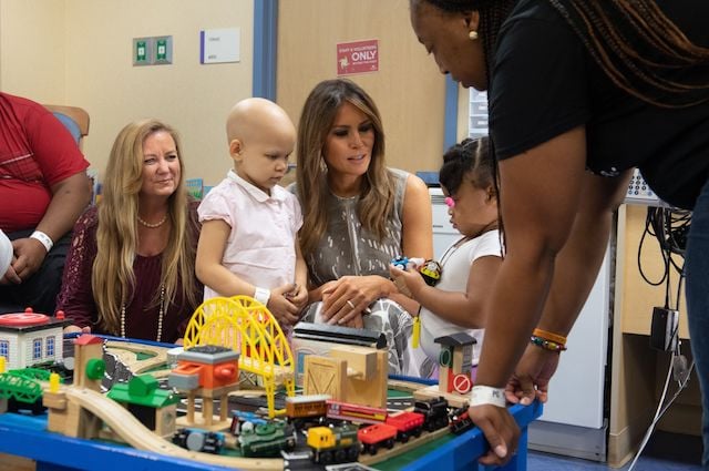 US First Lady Melania Trump plays with patients Essence Overton (L), 4 years old, and Natalayah Fields (R), 3 years old, following a roundtable discussion on neonatal abstinence syndrome (NAS) during a visit to Monroe Carell Jr. Children's Hospital at Vanderbilt in Nashville, Tennessee, July 24, 2018, as part of her "Be Best" campaign. (Photo credit: SAUL LOEB/AFP/Getty Images)