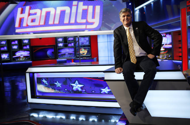 Fox News Channel anchor Sean Hannity poses for photographs as he sits on the set of his show "Hannity" at the Fox News Channel's studios in New York City, October 28, 2014. REUTERS/Mike Segar