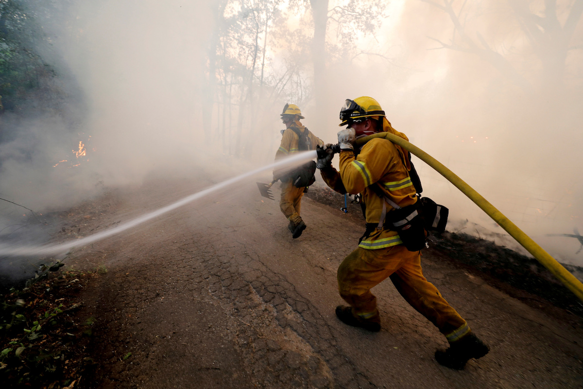 A firefighter knocks down hotspots to slow the spread of the River Fire (Mendocino Complex) in Lakeport, California, July 31, 2018. REUTERS/Fred Greaves/File Photo