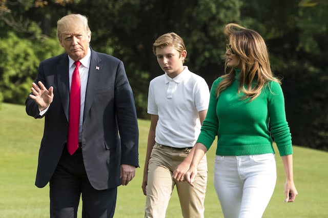 US President Donald Trump (L), his wife Melania Trump and their son Baron (C) disembark on the South Lawn upon his return to the White House after a weekend in Bedminster, in Washington, DC on August 19, 2018. (Photo credit: ERIC BARADAT/AFP/Getty Images)