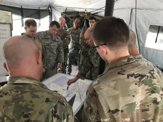Officers of the 2-108th Cavalry Squadron conduct a "war game" exercise to plan for the FTX (Photo: Joseph LaFave/ The Daily Caller)